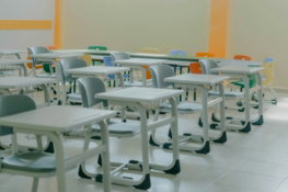 a-row-of-desks-and-chairs-in-a-room.jpg a row of desks and chairs in a room